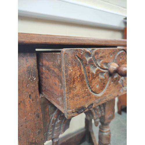 401 - 17th century style oak credence table, the shaped top above carved decoration, raised on turned legs... 