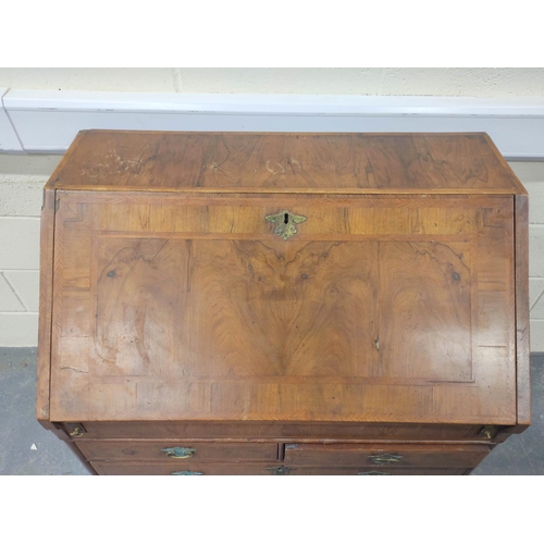 402 - 18th century feather banded walnut and pine bureau, the fall front enclosing a fitted interior of pi... 