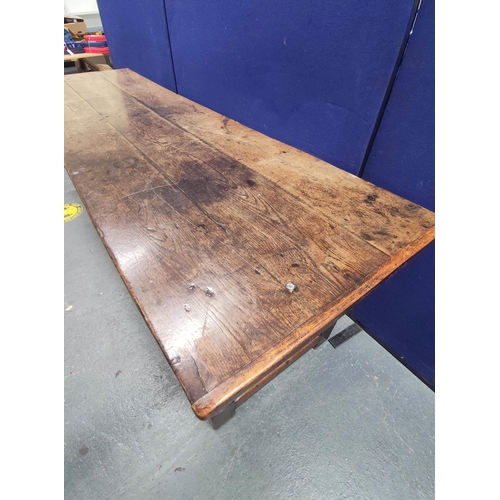 404 - 17th century style oak refectory table, with fixed plank top, above a carved frieze, raised on turne... 