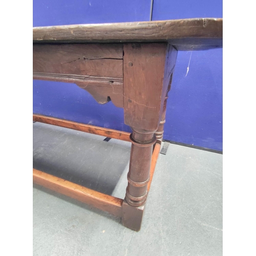 404 - 17th century style oak refectory table, with fixed plank top, above a carved frieze, raised on turne... 