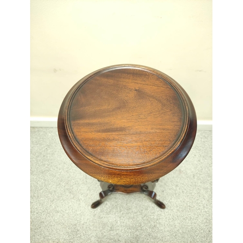 411 - Mahogany wig stand, the saucer top above open recess and two small drawers, on platform base with tr... 