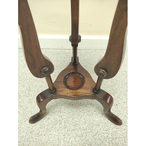 411 - Mahogany wig stand, the saucer top above open recess and two small drawers, on platform base with tr... 