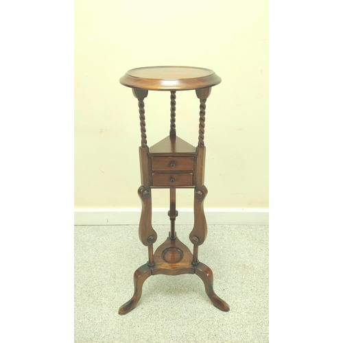 411 - Mahogany wig stand, the saucer top above open recess and two small drawers, on platform base with tr... 