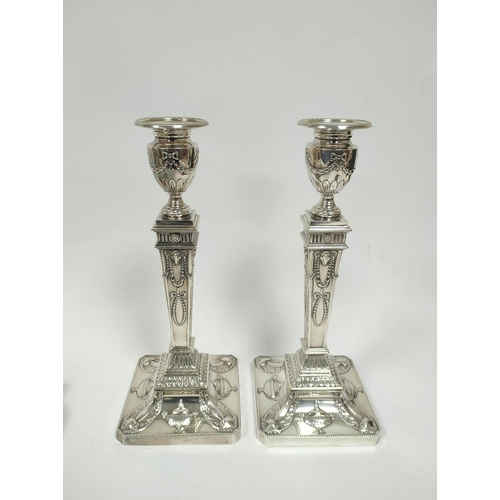 159 - Pair of silver table candlesticks of Neo Classical Adams style, with square inverted tapering stems ... 