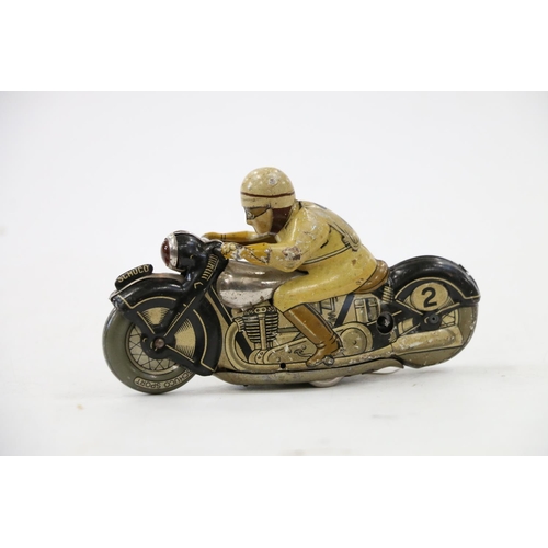 9 - Schuco of Germany, a tinplate clockwork motorcycle and rider #2 N1012, 13cm long. 