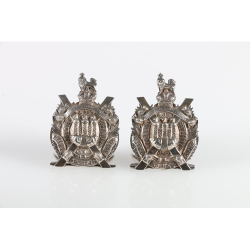 875 - Pair of King's Own Scottish Borderers silver place name or menu holders in the form of the KOSB cres... 