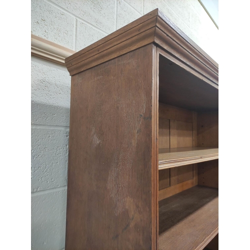 390 - Oak open library bookcase, c.1870's, in the manner of Philip Webb, the moulded pediment above three ... 