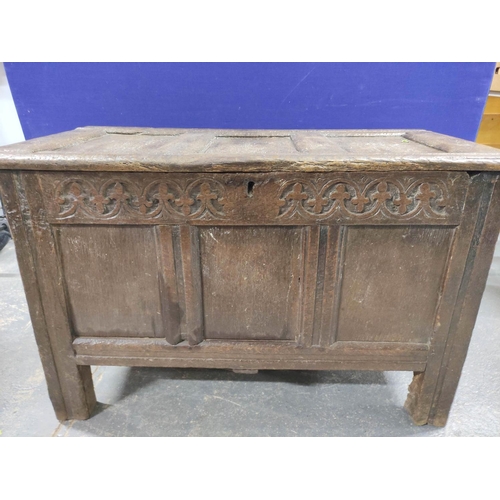 396 - 17th century or earlier oak coffer, the three panel front above frieze carved with fleur-de-lis abov... 