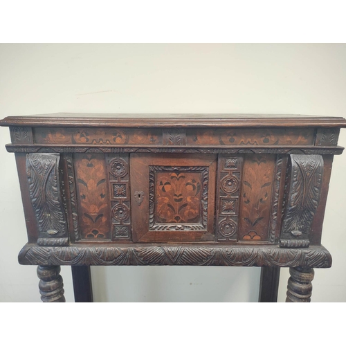 403 - Early 17th century style oak buffet, the carved inlaid front fitted with cupboards and inlaid decora... 