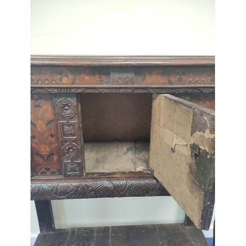 403 - Early 17th century style oak buffet, the carved inlaid front fitted with cupboards and inlaid decora... 