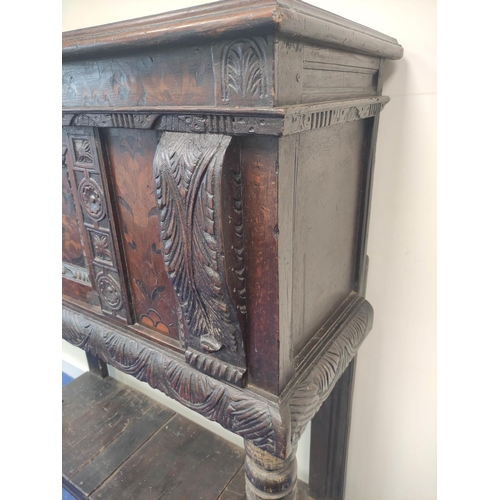 403 - Early 17th century style oak buffet, the carved inlaid front fitted with cupboards and inlaid decora... 