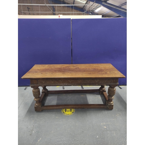 416 - 17th century style oak refectory table, the rectangular plank top above carved frieze, fitted with a... 