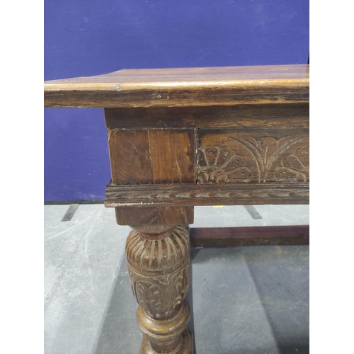 416 - 17th century style oak refectory table, the rectangular plank top above carved frieze, fitted with a... 