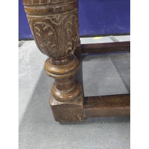 416 - 17th century style oak refectory table, the rectangular plank top above carved frieze, fitted with a... 