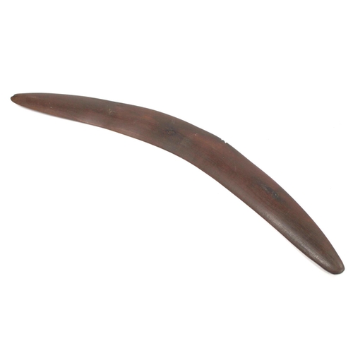 354 - Antique hardwood boomerang of plain curved form, 65cm long, some damages.