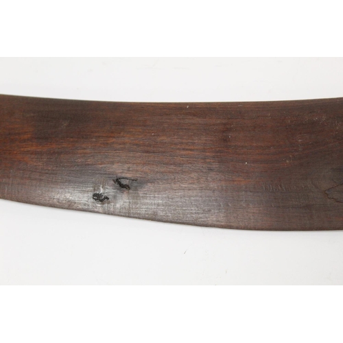 354 - Antique hardwood boomerang of plain curved form, 65cm long, some damages.