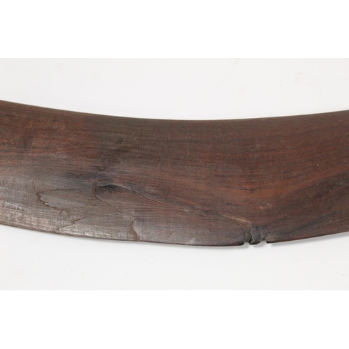 354 - Antique hardwood boomerang of plain curved form, 65cm long, some damages.