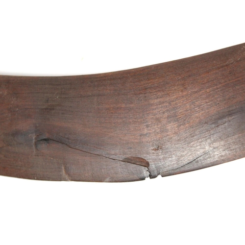 354 - Antique hardwood boomerang of plain curved form, 65cm long, some damages.