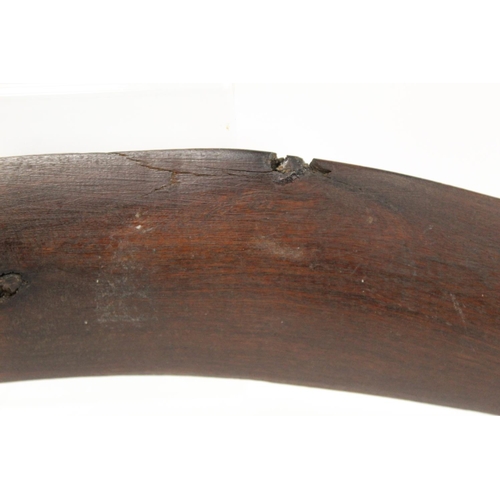 354 - Antique hardwood boomerang of plain curved form, 65cm long, some damages.