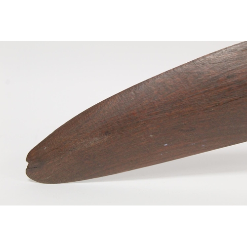 354 - Antique hardwood boomerang of plain curved form, 65cm long, some damages.