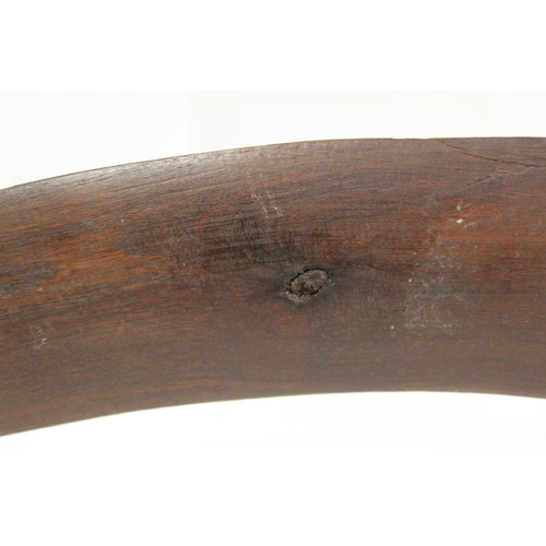 354 - Antique hardwood boomerang of plain curved form, 65cm long, some damages.