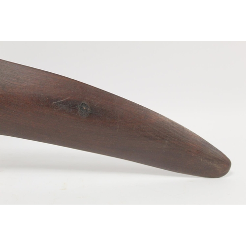 354 - Antique hardwood boomerang of plain curved form, 65cm long, some damages.