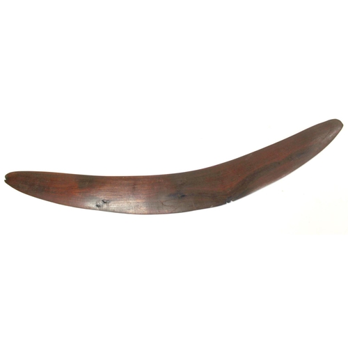 354 - Antique hardwood boomerang of plain curved form, 65cm long, some damages.