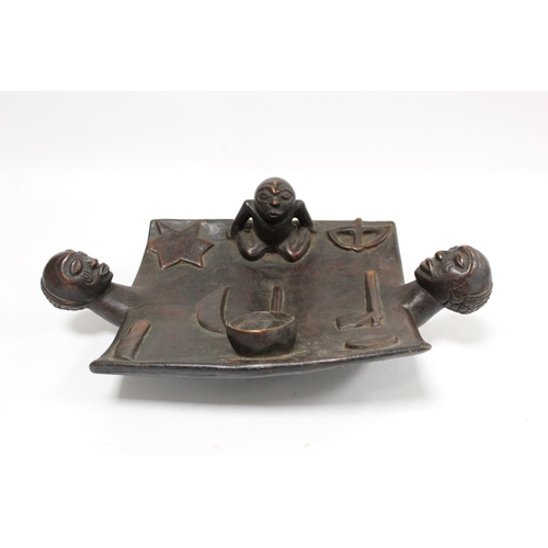 356 - African carved hardwood divination dish of rectangular form with twin mask head handles, surmounted ... 