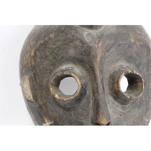 357 - African tribal mask of ovoid form with cylindrical eyes, mouth with jagged teeth and stylised hair, ... 