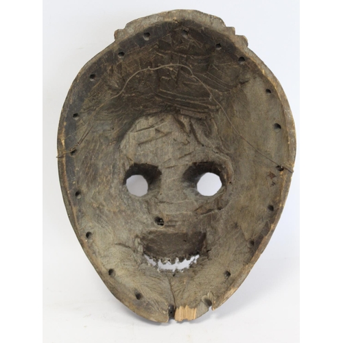 357 - African tribal mask of ovoid form with cylindrical eyes, mouth with jagged teeth and stylised hair, ... 