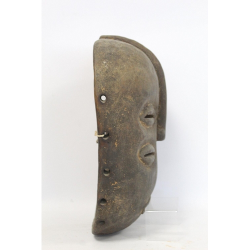 359 - African tribal carved wooden mask of oval form with four pierced lidded eyes, central raised nose an... 