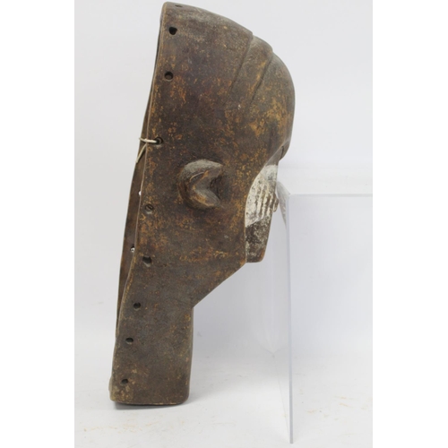 360 - African tribal carved wooden mask of large elongated form with arched brow, conical ribbed eyes, tri... 