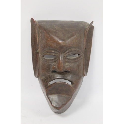 366 - African carved hardwood monkey mask decorated with white and red pigments, with cane binding and fri... 