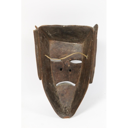 366 - African carved hardwood monkey mask decorated with white and red pigments, with cane binding and fri... 