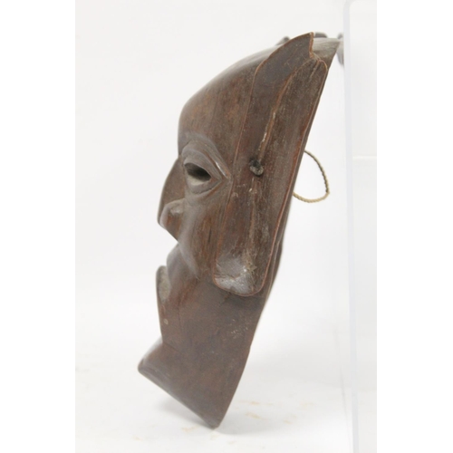 366 - African carved hardwood monkey mask decorated with white and red pigments, with cane binding and fri... 