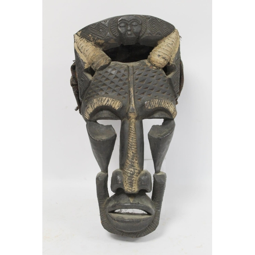 367 - African zoomorphic pierced and carved wooden mask decorated with white pigment, with woven cane and ... 