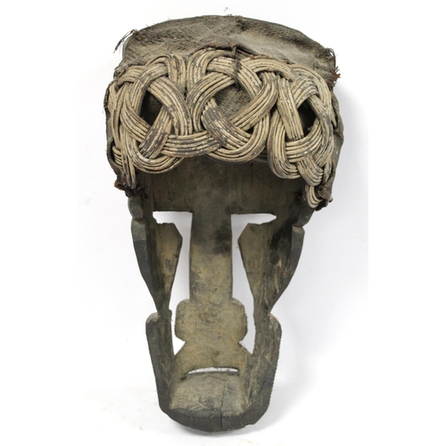 367 - African zoomorphic pierced and carved wooden mask decorated with white pigment, with woven cane and ... 