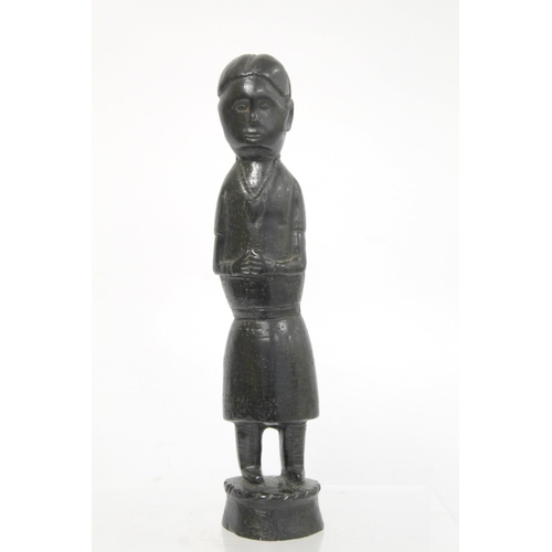 369 - Ethnic, probably African, carved ebony standing figure of a man (European missionary / priest?) on c... 