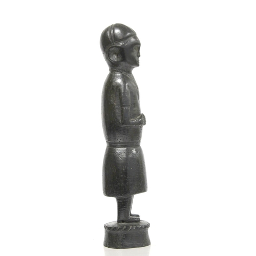 369 - Ethnic, probably African, carved ebony standing figure of a man (European missionary / priest?) on c... 