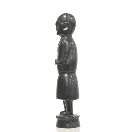 369 - Ethnic, probably African, carved ebony standing figure of a man (European missionary / priest?) on c... 