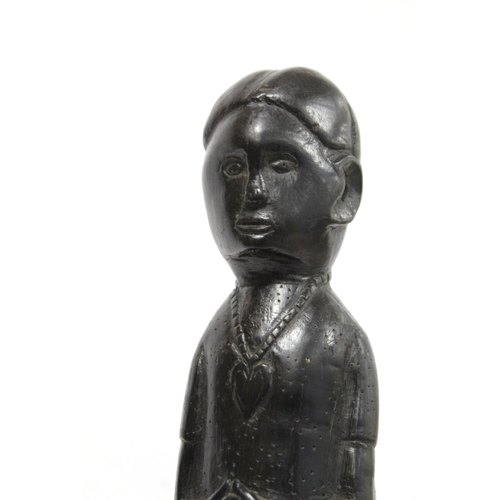 369 - Ethnic, probably African, carved ebony standing figure of a man (European missionary / priest?) on c... 