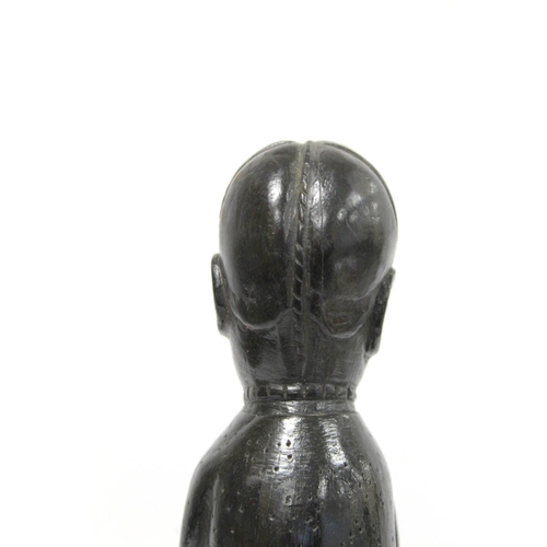 369 - Ethnic, probably African, carved ebony standing figure of a man (European missionary / priest?) on c... 