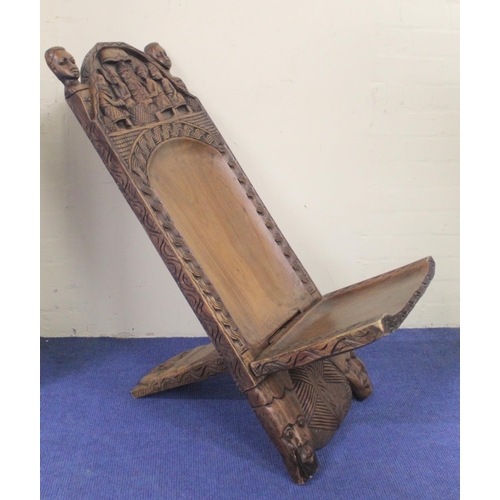 373 - Modern African Nigerian carved hardwood folding chair in two parts, the arched top with mask head fi... 