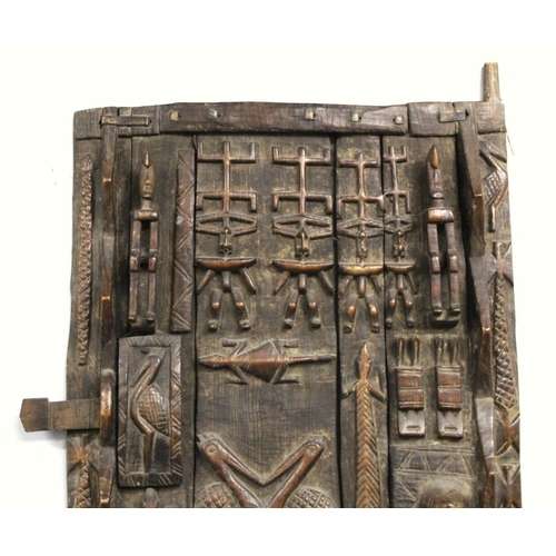 375 - African carved wooden door, probably Dogon, Mali, profusely decorated with figures and animals, 185c... 