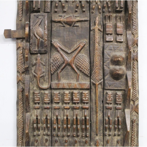 375 - African carved wooden door, probably Dogon, Mali, profusely decorated with figures and animals, 185c... 