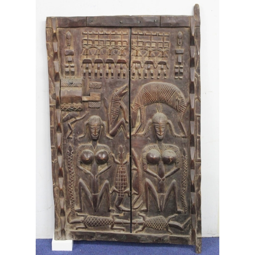 376 - West African carved wooden door, probably Ivory Coast, profusely decorated with figures and animals,... 