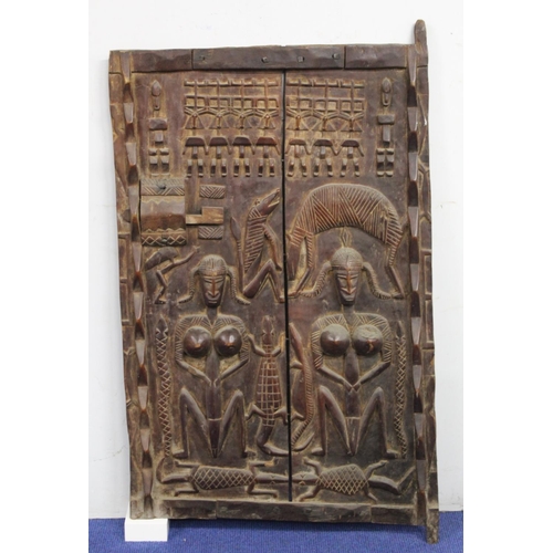 376 - West African carved wooden door, probably Ivory Coast, profusely decorated with figures and animals,... 