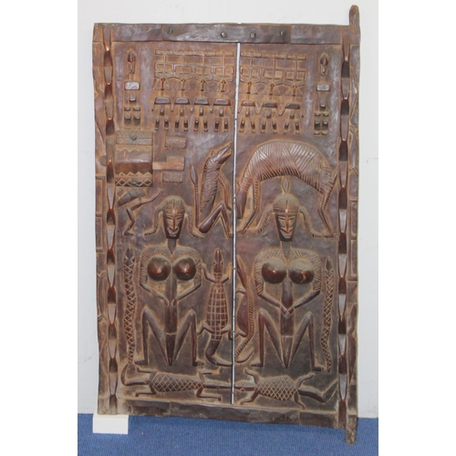 376 - West African carved wooden door, probably Ivory Coast, profusely decorated with figures and animals,... 