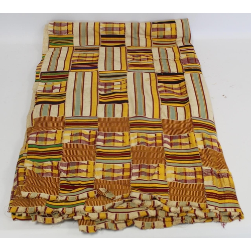 377 - African Asanti Kente cloth in woven silk and cotton striped fabrics in predominantly yellow, cream, ... 