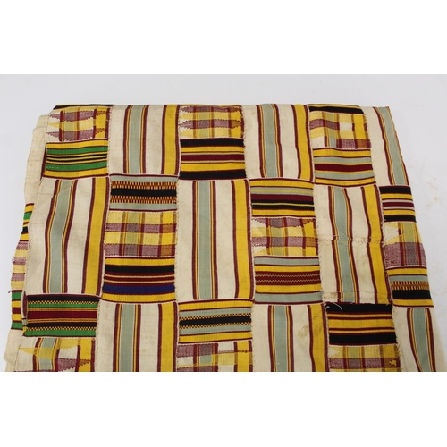 377 - African Asanti Kente cloth in woven silk and cotton striped fabrics in predominantly yellow, cream, ... 